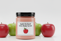 9oz Apple Orchard Glow Body Scrub with smooth texture in clear jar with black lid
