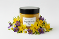 Turmeric Sugar Scrub 9oz in clear jar with black lid and Easter theme